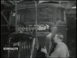 1948: OPEL TRUCK FACTORY: EXT Opel automotive factory w/ trucks driving away. VS Truck assembly line, tires rolling down ramp, German worker placing tire, line of Opel trucks driving out of factory. (private company, currently subsidiary of GM) Instructional Video