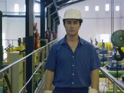 TS MS stern and aggressive looking worker walking to camera and approaches camera until out of focus, RED R3D 4K Stock Footage