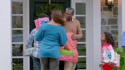 Grandfather welcomes family home for the holidays, hugs all around (dolly-shot) Stock Footage