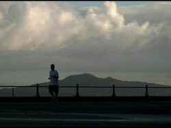Jogger / Runner Silhouette Runs Past Perfect Mountain Backdrop Stock Footage