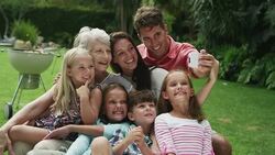 Multi-generation family taking self-portrait with camera phone Stock Footage