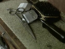 ECU SELECTIVE FOCUS Barber's scissors, clippers blade and brush on table top, Brooklyn, New York City, New York State, USA Stock Footage
