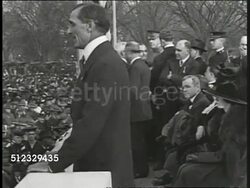 1917: LIBERTY BONDS: Speaker standing in podium w/ seats at Liberty Bond rally, crowd below. VS Crowd of people at rally. MS Douglas Fairbanks Sr., Charlie Chaplin, Mary Pickford & unidentified man in suit in front of crowd shouting, cheering. Instructional Video