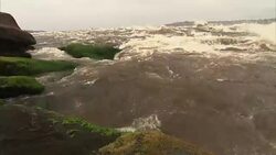 Medium shot of fast flowing water over rocks on edge on Congo river Stock Footage