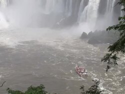 WS View of boat moving near waterfall / IguazÃƒÂº waterfall, ParanÃƒÂ¡, Brasil Stock Footage