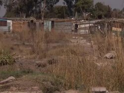 Radiation warning sign and shanty town News Clip