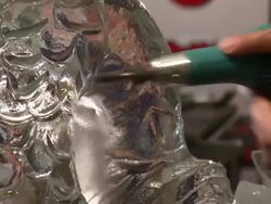 An artist uses a tool to carve details into an ice sculpture. Stock Footage