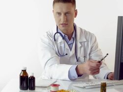 Doctor consulting with patient at desk Stock Footage