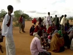UN officer with loudspeaker and refugee crowd Stock Footage