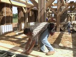 WS PAN Carpenter measuring wood plank while framing an energy efficient post / Grass Lake, Michigan, USA Stock Footage