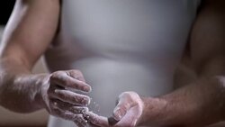 SLO MO Male gymnast chalking his hands Stock Footage
