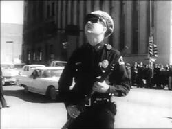 B/W 1963 policeman in uniform holding gun looking up / Kennedy assassination / Dallas Stock Footage