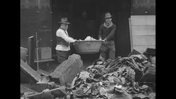 People cleaning up wreckage after flood in US in 1930s News Clip