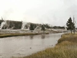 WS View of Steam from hot thermal springs rising up near sunrise at River Firehole, UNESCO World Heritage Site. Firehole River, Yellowstone National Park / Yellowstone, Wyoming, United States Stock Footage