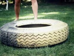 HD: Athlete Whacking A Truck Tire Stock Footage