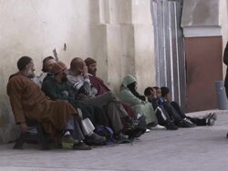 MS Shot of people sitting on side of street / Marrakesh, Morocco Stock Footage