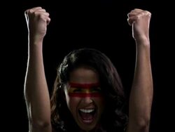 Woman with red and yellow face paint cheering Stock Footage