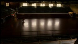 An athlete practices basketball in an empty gym. Stock Footage
