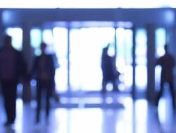 People moves through revolving door Stock Footage