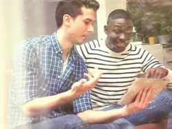 MS PAN Two young men playing cards Stock Footage