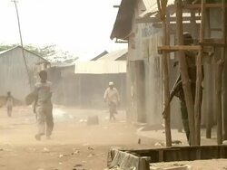 People walking by a windy and smoky area Stock Footage