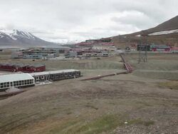Panorama view of Longyearbyen industrial zone with mountains covered by snow in the background Stock Footage