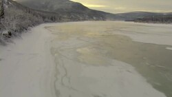 A thin crust of ice covers the Yukon River in Canada. Stock Footage