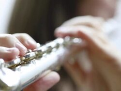 Young woman playing flute Stock Footage