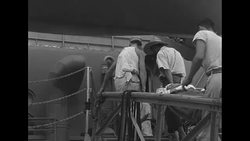 Wounded soldiers of UN Forces in Korea being loaded onto ship during Korean War News Clip