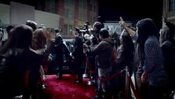 Hollywood couple climb out of limousine and greet fans and paparazzi on crowded red carpet at awards show Stock Footage