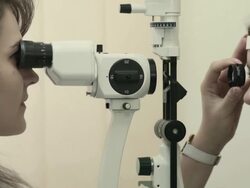 Young woman having her eyesight examined Stock Footage