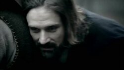 Nostradamus removes his hat to listen to a villager's lungs. Stock Footage