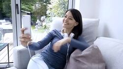 Woman at home sitting on the couch and taking selfies Stock Footage