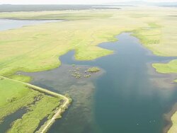 WS AERIAL View over green landscape and lake / Wyoming, United States Stock Footage