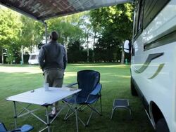 WS mature man stands in front of camper van stretching his arms out/Bungay/Suffolk/UK Stock Footage