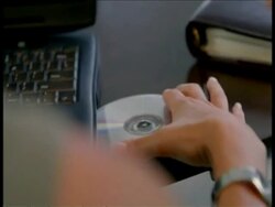 CU hand inserting CD into disc drive Stock Footage