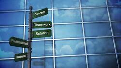 Clouds are reflected in a glass building behind a shifting signpost of business terms. Stock Footage