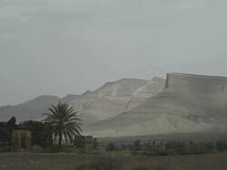 Stunning mountains overlook an old, rustic building. Stock Footage