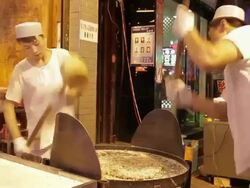 MS People making a traditional food in night market /Xi'an, Shaanxi, China Stock Footage