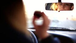 beautiful girl checking her makeup in her car Stock Footage