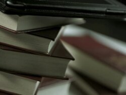 HD: Digital Tablet Against Printed Book Stock Footage