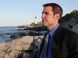 MS Man standing on rocks looking out over ocean / Portland, ME, United States Stock Footage