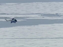 WS, TS, Helicopter landing on icebreaker traveling through broken pack ice, Russia Stock Footage