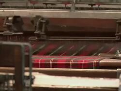 CU Tartan kilt being woven on a loom / Edinburgh, Scotland, United Kingdom Stock Footage