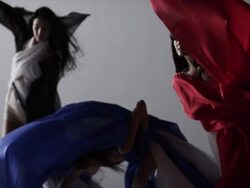 three woman dancers dancing, draped with colors of silk fabric that move with them Stock Footage