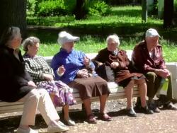 MS Shot of senior citizens group sitting on park bench talking to one another / St. Petersburg, Russia Stock Footage
