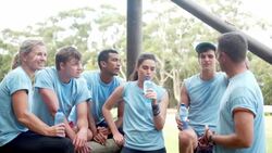 Team resting and talking at boot camp obstacle course Stock Footage