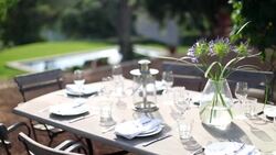 Table with luxury place settings in backyard Stock Footage