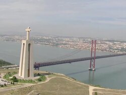 WS AERIAL DS View of Cristo Rei" and "Ponte 25 de Abril" on Tagus River / Almada, Setubal, Portugal Stock Footage