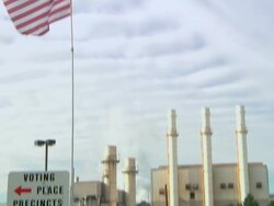 November 2, 2010 TD A voter walks past American flag at voter registration / Dearborn, Michigan, United States Stock Footage